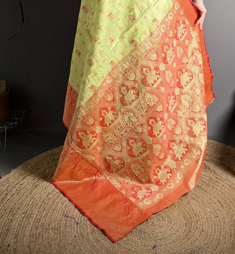 green kanjeevaram silk blend zari woven saree with unstitched blouse piece.