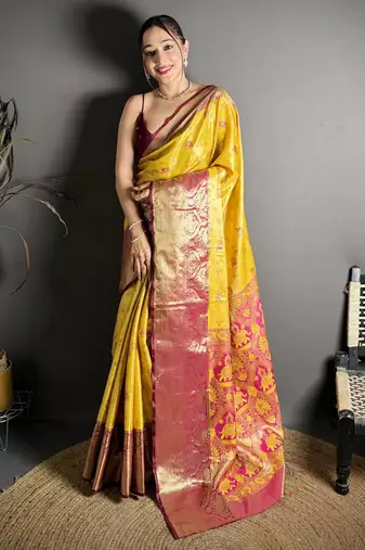 yellow kanjeevaram silk blend zari woven saree with unstitched blouse piece.