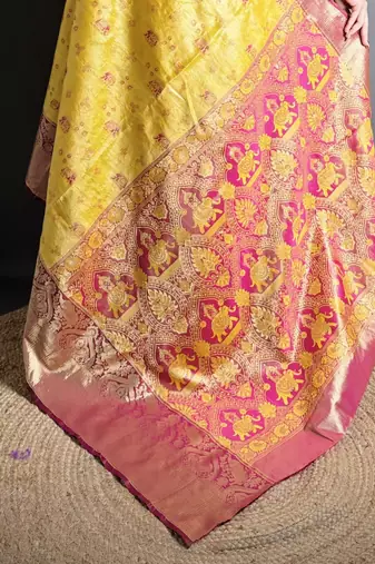 yellow kanjeevaram silk blend zari woven saree with unstitched blouse piece.