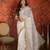 Cream tissue satin embroidered sequin saree with unstitched blouse piece.