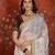 Cream tissue satin embroidered sequin saree with unstitched blouse piece.