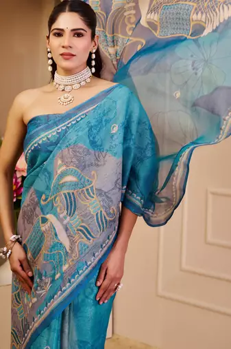 Blue shimmer printed zari saree with unstitched blouse piece.
