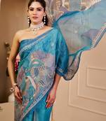 Blue shimmer printed zari saree with unstitched blouse piece.