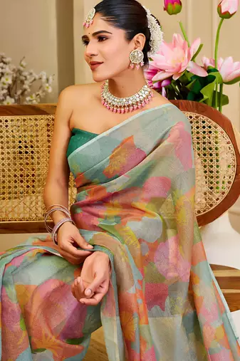 Sea green shimmer printed zari saree with unstitched blouse piece.