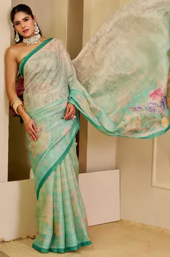 Turquoise shimmer printed zari saree with unstitched blouse piece.