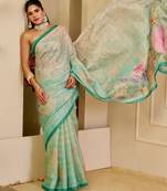 Turquoise shimmer printed zari saree with unstitched blouse piece.