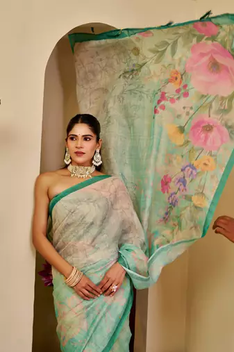 Turquoise shimmer printed zari saree with unstitched blouse piece.