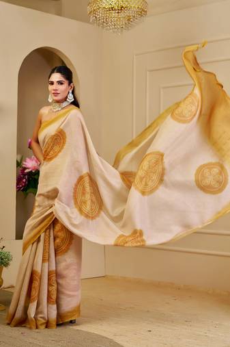 Beige shimmer printed zari saree with unstitched blouse piece.