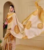Beige shimmer printed zari saree with unstitched blouse piece.