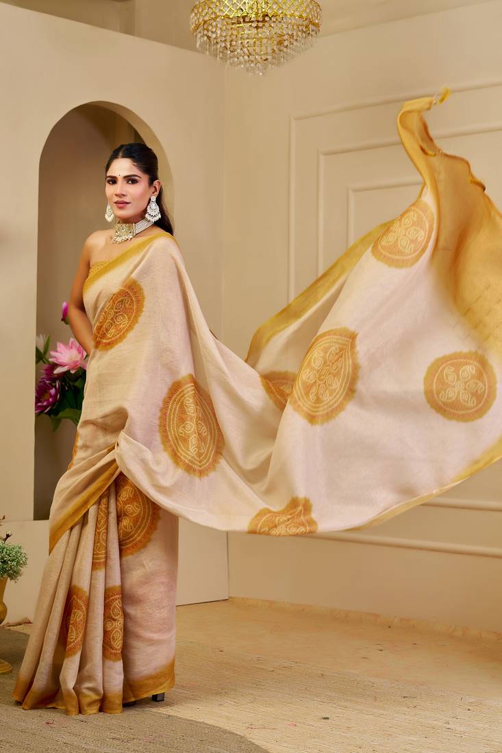 Beige shimmer printed zari saree with unstitched blouse piece.