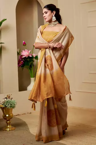 Beige shimmer printed zari saree with unstitched blouse piece.