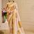 Beige shimmer printed zari saree with unstitched blouse piece.