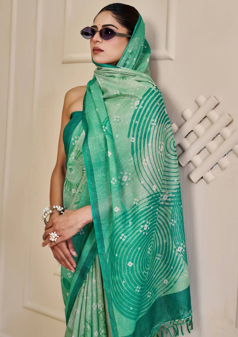 Turquoise shimmer printed zari saree with unstitched blouse piece.