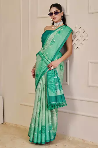 Turquoise shimmer printed zari saree with unstitched blouse piece.