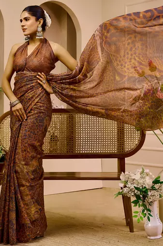 Brown shimmer printed zari saree with unstitched blouse piece.
