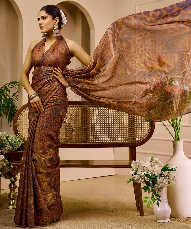 Brown shimmer printed zari saree with unstitched blouse piece.