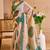 Beige shimmer printed zari saree with unstitched blouse piece.