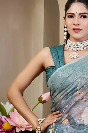 Turquoise shimmer printed zari saree with unstitched blouse piece.