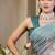 Turquoise shimmer printed zari saree with unstitched blouse piece.