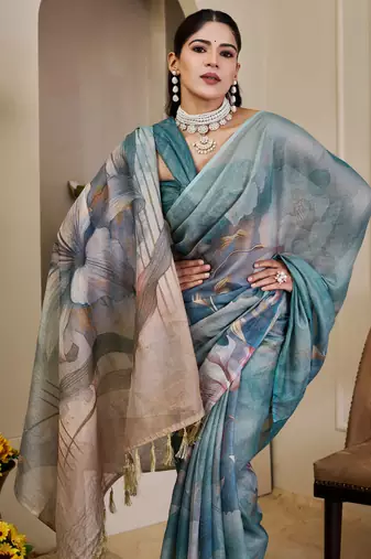 Turquoise shimmer printed zari saree with unstitched blouse piece.