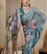 Turquoise shimmer printed zari saree with unstitched blouse piece.