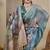 Turquoise shimmer printed zari saree with unstitched blouse piece.