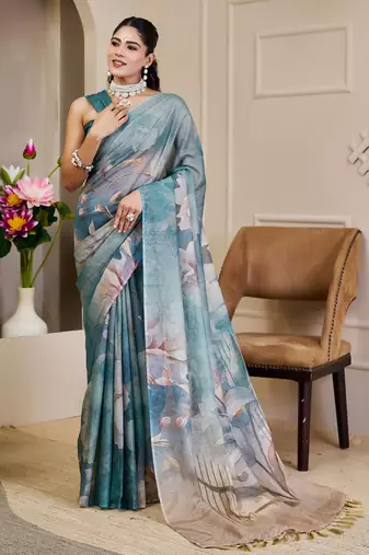 Turquoise shimmer printed zari saree with unstitched blouse piece.