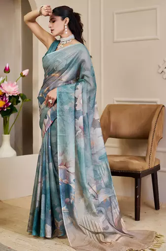 Turquoise shimmer printed zari saree with unstitched blouse piece.