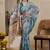 Turquoise shimmer printed zari saree with unstitched blouse piece.