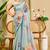 Sky blue shimmer printed zari saree with unstitched blouse piece.
