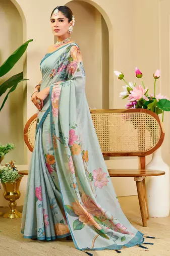 Sky blue shimmer printed zari saree with unstitched blouse piece.