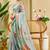 Sky blue shimmer printed zari saree with unstitched blouse piece.
