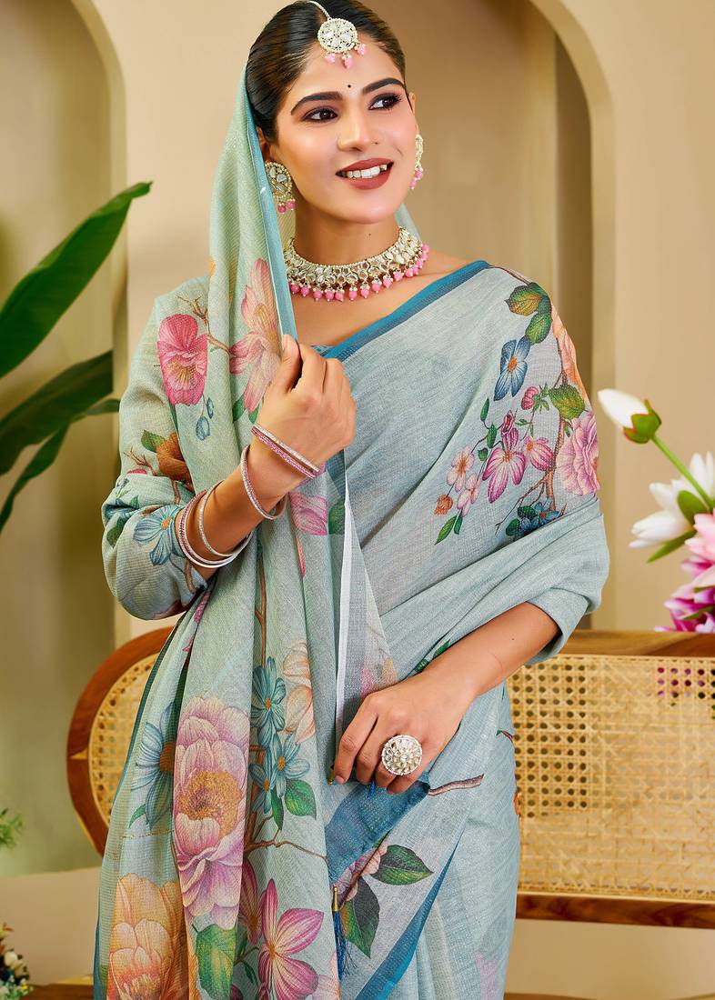 Sky blue shimmer printed zari saree with unstitched blouse piece.