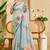 Sky blue shimmer printed zari saree with unstitched blouse piece.