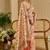 Peach shimmer printed zari saree with unstitched blouse piece.