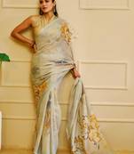 Sky blue shimmer printed zari saree with unstitched blouse piece.