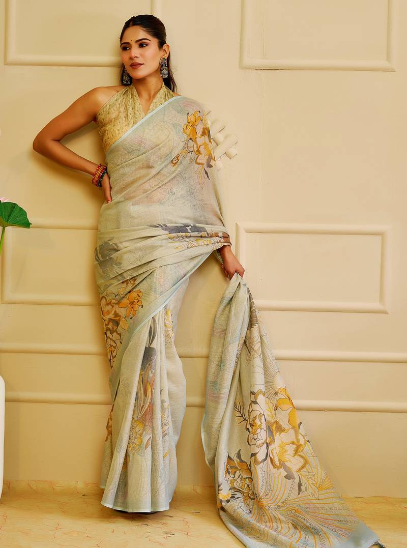 Sky blue shimmer printed zari saree with unstitched blouse piece.