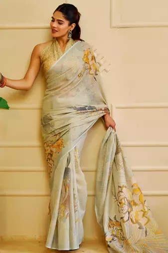 Sky blue shimmer printed zari saree with unstitched blouse piece.