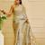 Sky blue shimmer printed zari saree with unstitched blouse piece.