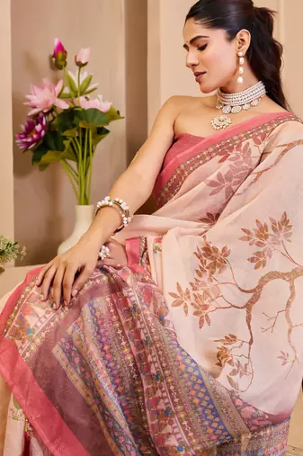 Peach shimmer printed zari saree with unstitched blouse piece.