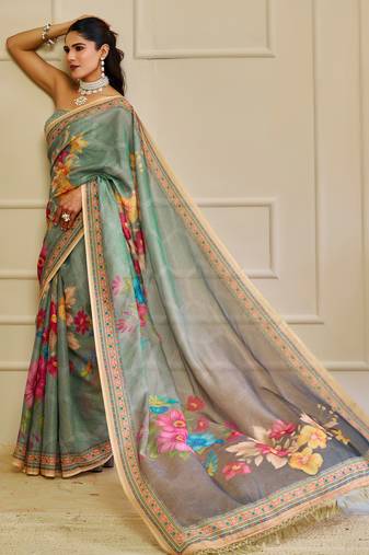 Sea green shimmer printed zari saree with unstitched blouse piece.