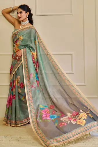 Sea green shimmer printed zari saree with unstitched blouse piece.