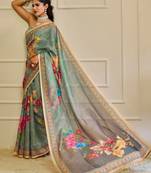 Sea green shimmer printed zari saree with unstitched blouse piece.