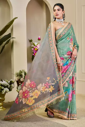 Sea green shimmer printed zari saree with unstitched blouse piece.