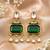 gold plated pachi kundan green stone studded dangler earrings