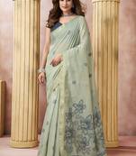 Sage green linen silk blend saree with floral woven pallu & tassels