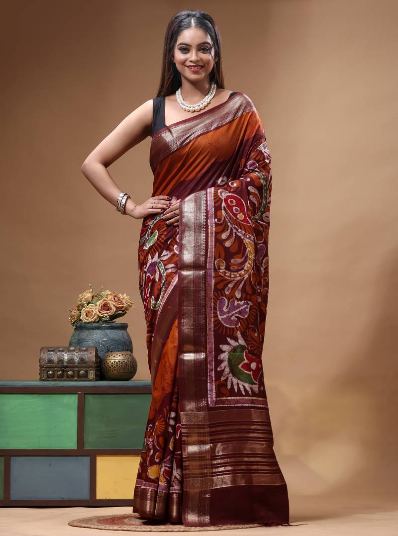 rust orange & maroon hand-painted silk blend saree with floral paisley print & golden zari border