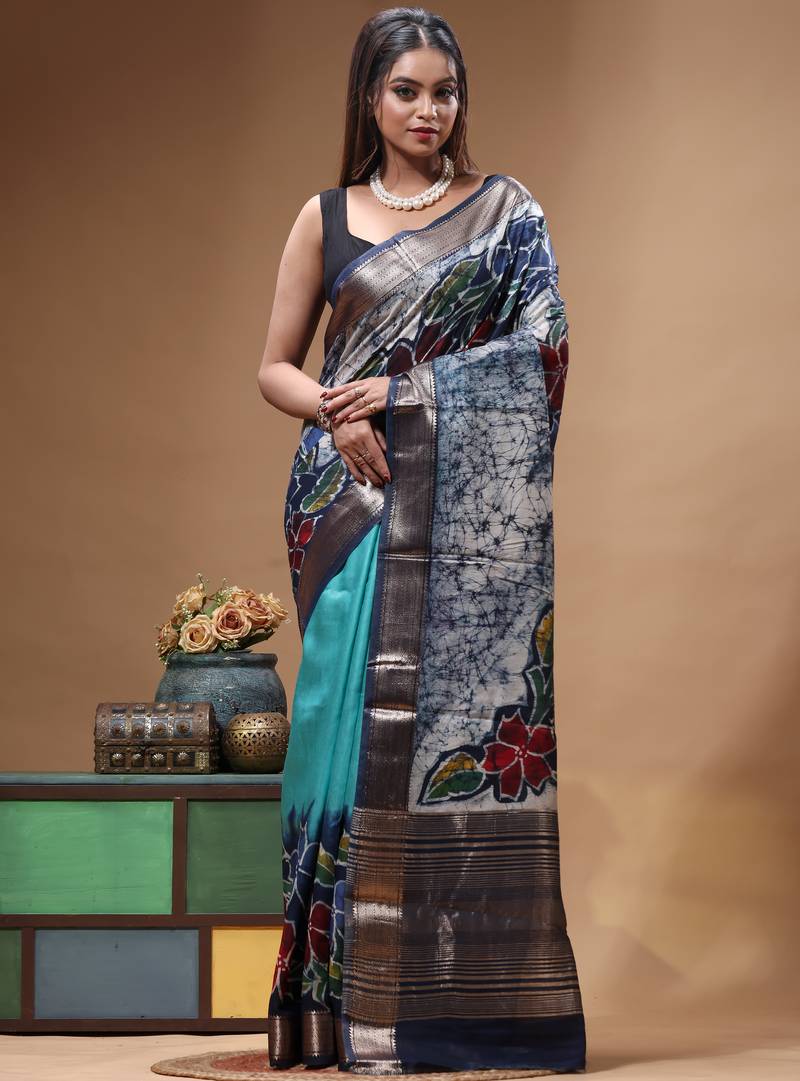 sky blue & navy blue hand-painted silk blend saree with floral batik print & golden zari border