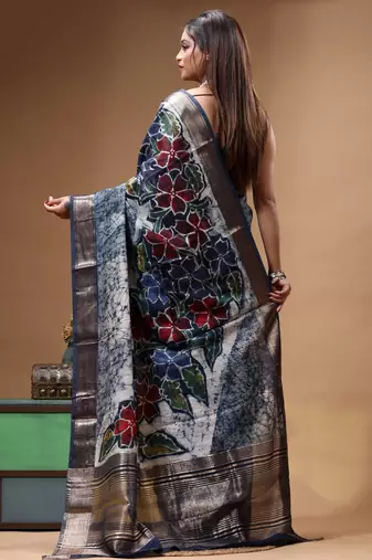 sky blue & navy blue hand-painted silk blend saree with floral batik print & golden zari border
