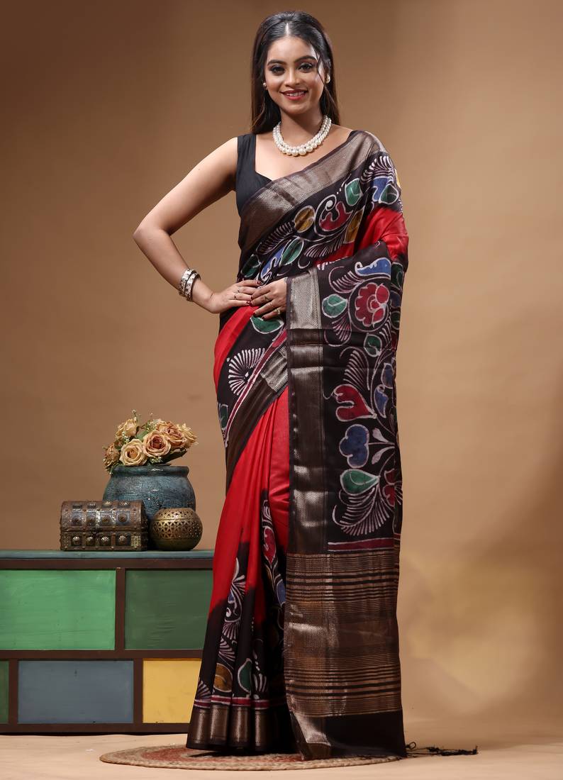 red & black hand-painted silk blend saree with multicolor floral motifs & golden zari border